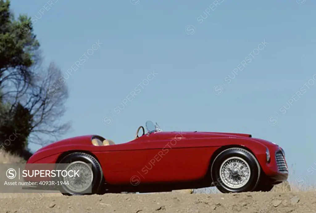 1951 Ferrari 166 MM Barchetta beauty profile Lusso touring race car. The 166 MM Touring Barchetta, a Ferrari masterpiece, still increase pulse rates fifty-five years later. It is the first Ferrari sports car; all previous cars were strictly for racing. Craftsmen welded a tubular frame with a 2,200 mm wheelbase to hand-formed body panels. Beneath the hood resides a Colombo designed 1,995 cc 60-degree V-12. The 166 MM was arguably the world's fastest sports car in its day. In the heyday, it record