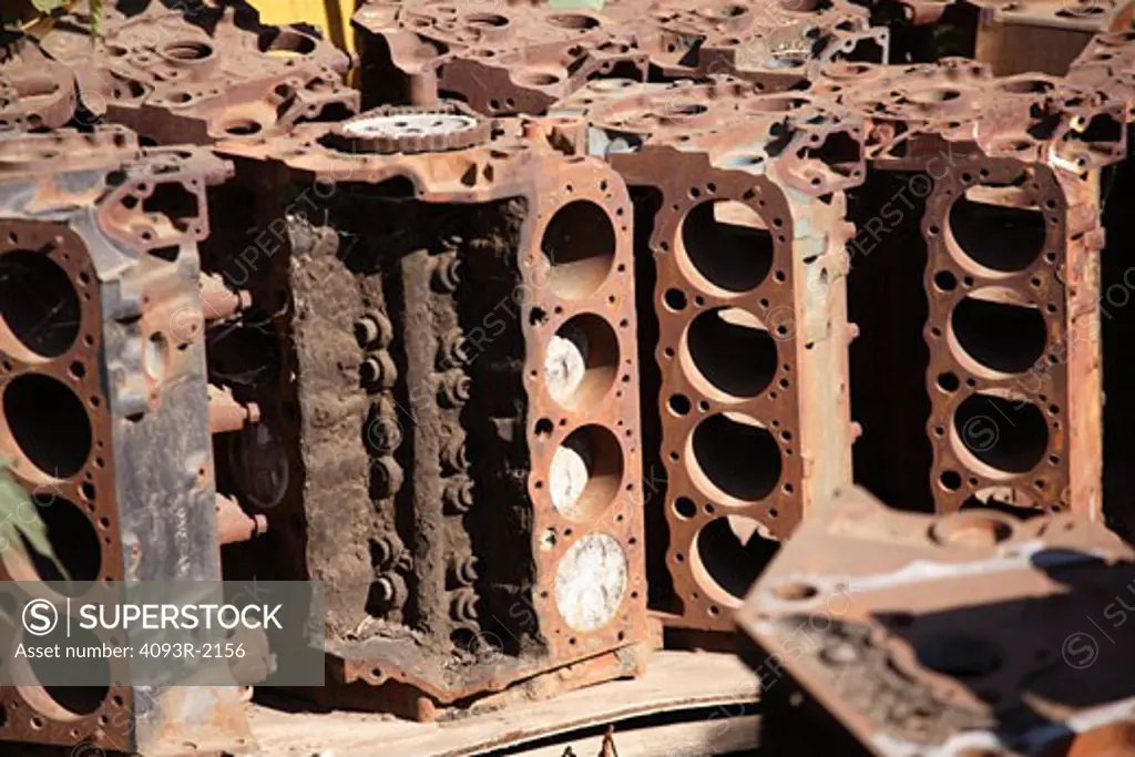 Old V8 engine blocks in a junk yard.