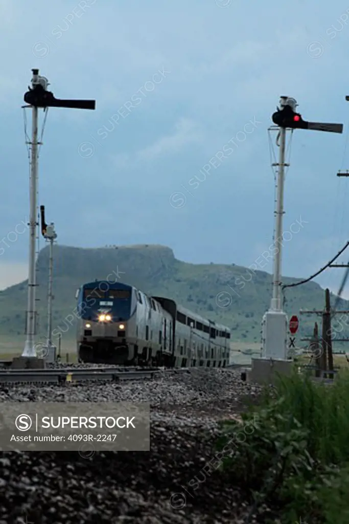 Amtrak Southwest Chief passenger train at Levy New Mexico with railroad signals in the foreground.