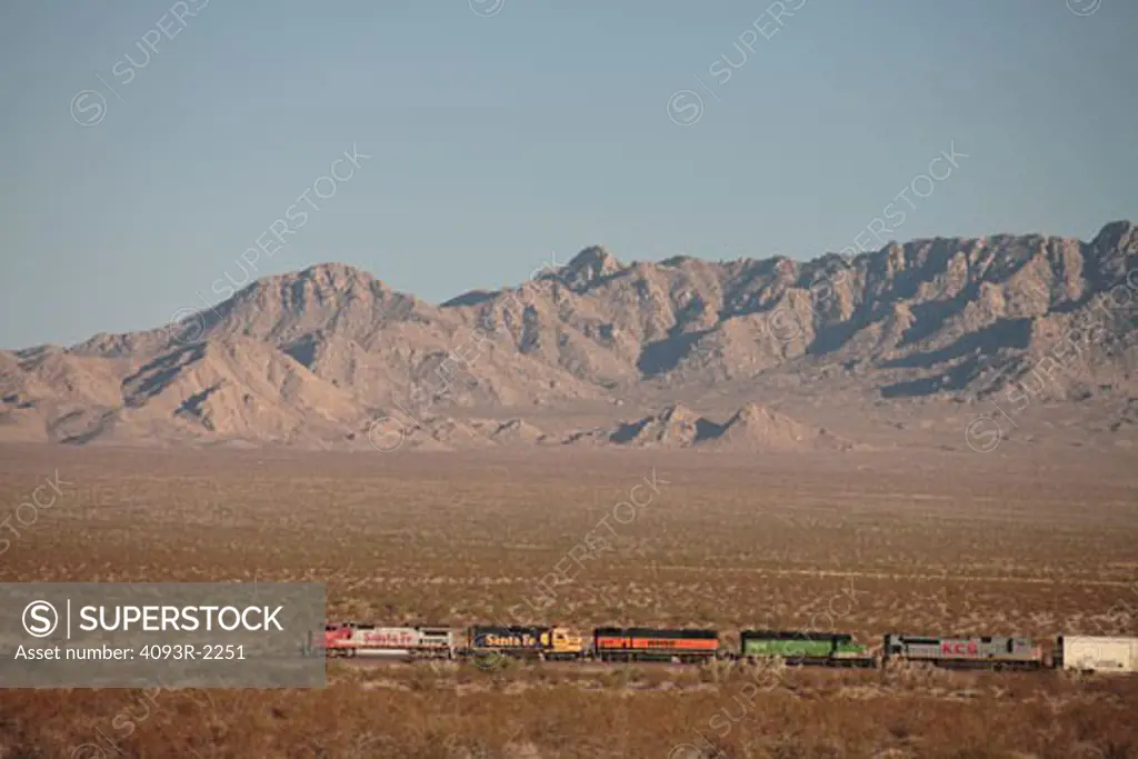 BNSF freight train at Amboy California. in the distance pulled back view mountains and desert in the background