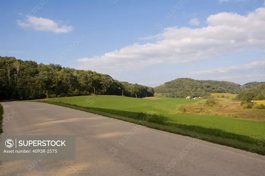 Pastoral road through summer farmscape, Spring Green, Wiscon