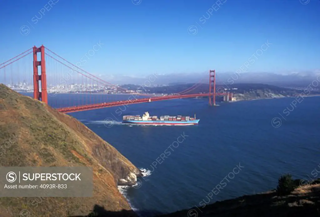 Commercial container ship bulk carrier cargo Golden Gate Bridge San Francisco Bay inlet suspension bridge