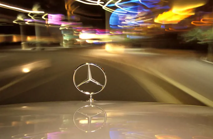 detail Mercedes Benz hood ornament badge logo lights street city
