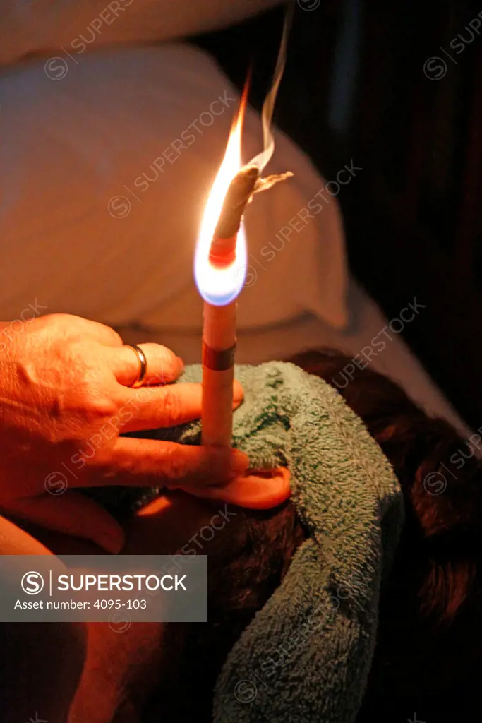 Person getting ear candling treatment