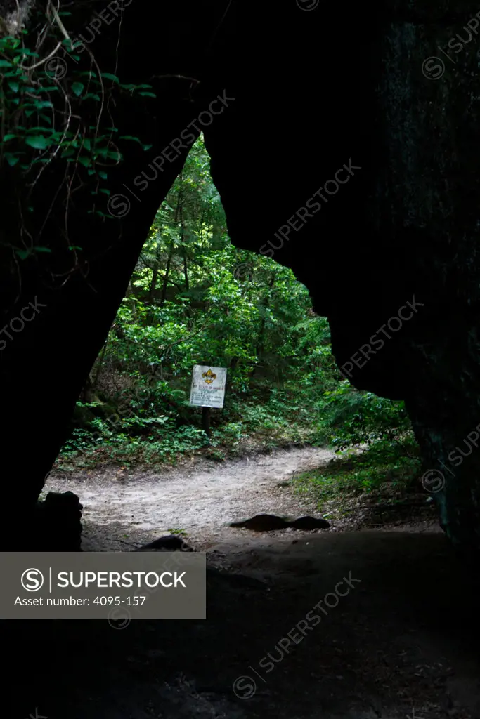 Sign beyond a space through joining walls of a canyon, Dismals Canyon, Franklin County, Alabama, USA
