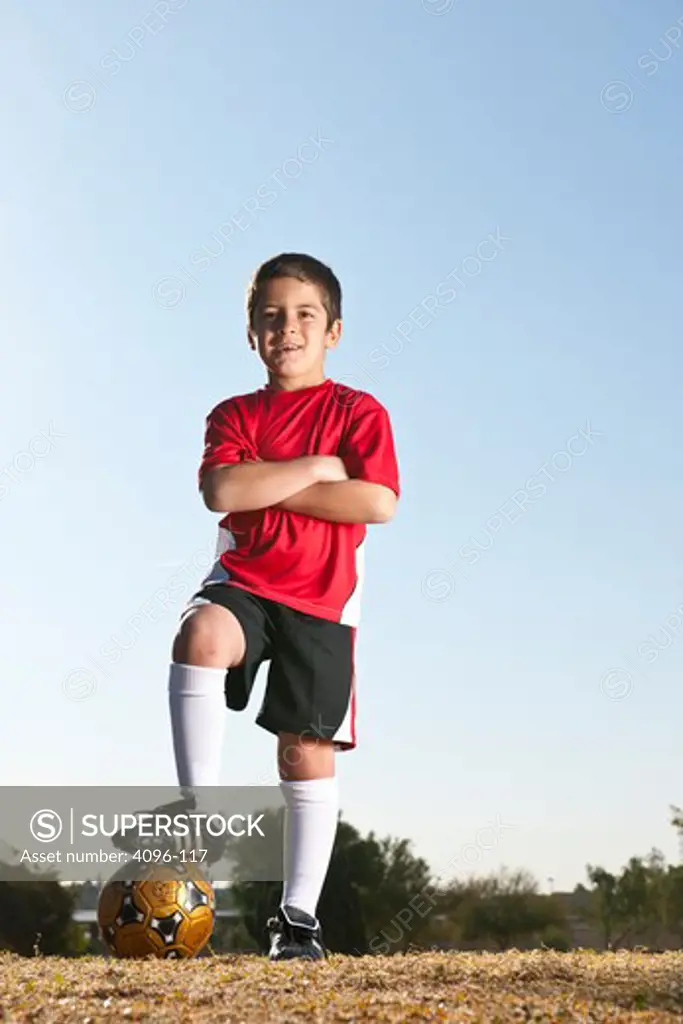 Boy standing with a soccer ball