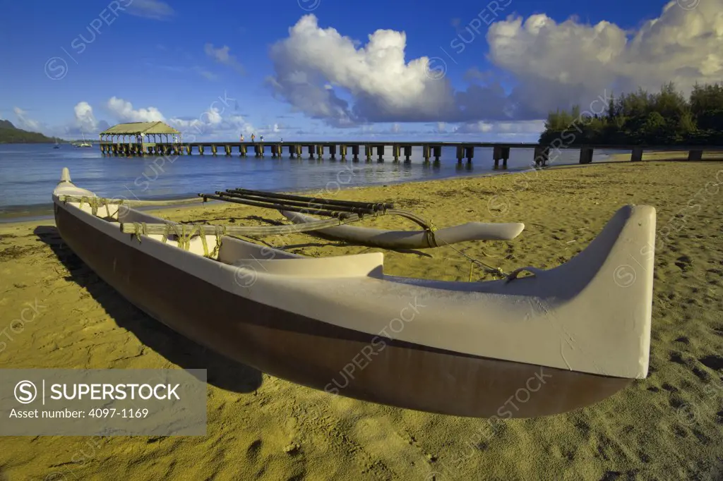 Boat on the beach with pier in the background, Hanalei Harbor, Hanalei Bay, Kauai, Hawaii, USA