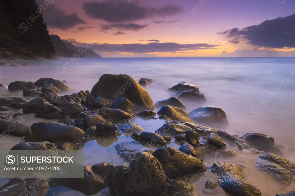 Rocks on the beach at sunset, Na Pali Coast, Kauai, Hawaii, USA