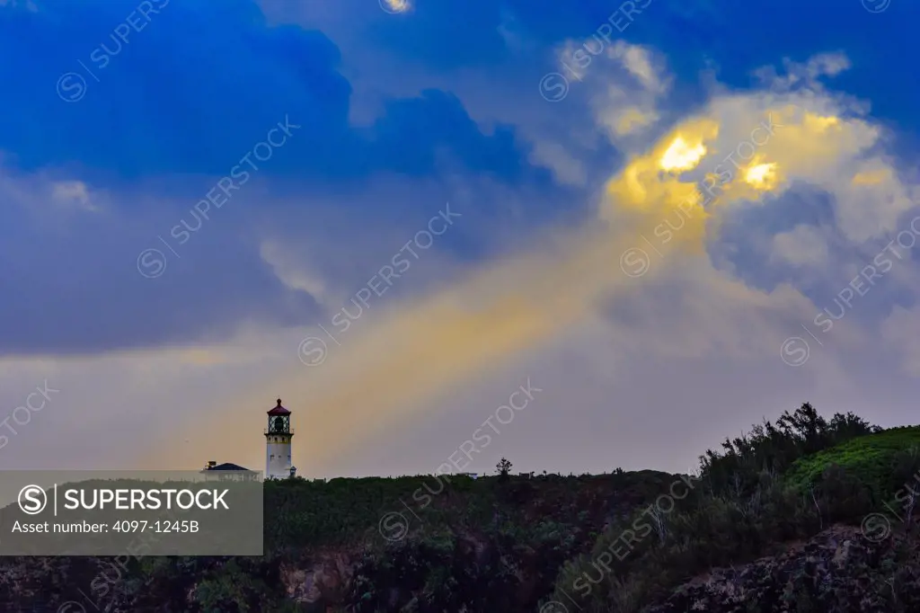 Lighthouse on a cliff at dusk, Kilauea Lighthouse, Secret Beach, Kauai, Hawaii, USA