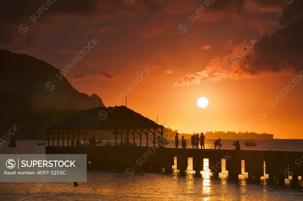 Tourists enjoying at a pier, Na Pali Coast, Hanalei, Kauai, Hawaii, USA