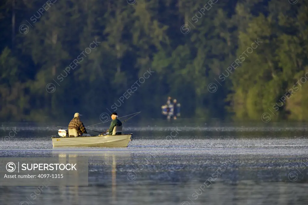 Tourists fishing in the lake, Elk Lake, Saanich Peninsula, Vancouver Island, British Columbia, Canada