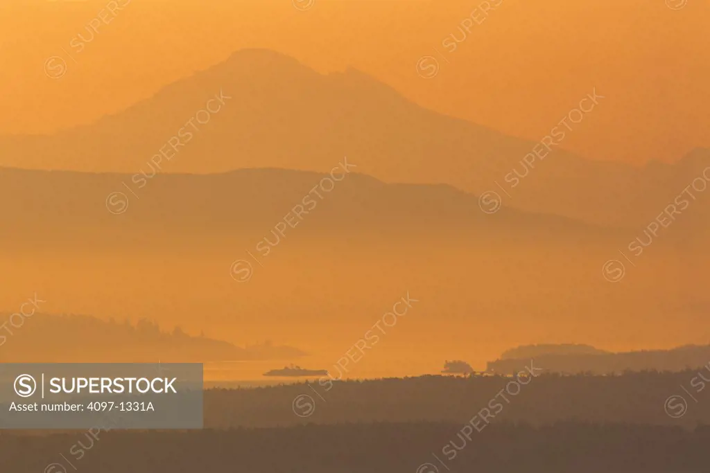 Mountain peak covered with fog at sunrise, Mt Baker, Haro Strait, Saanich Peninsula, Vancouver Island, British Columbia, Canada