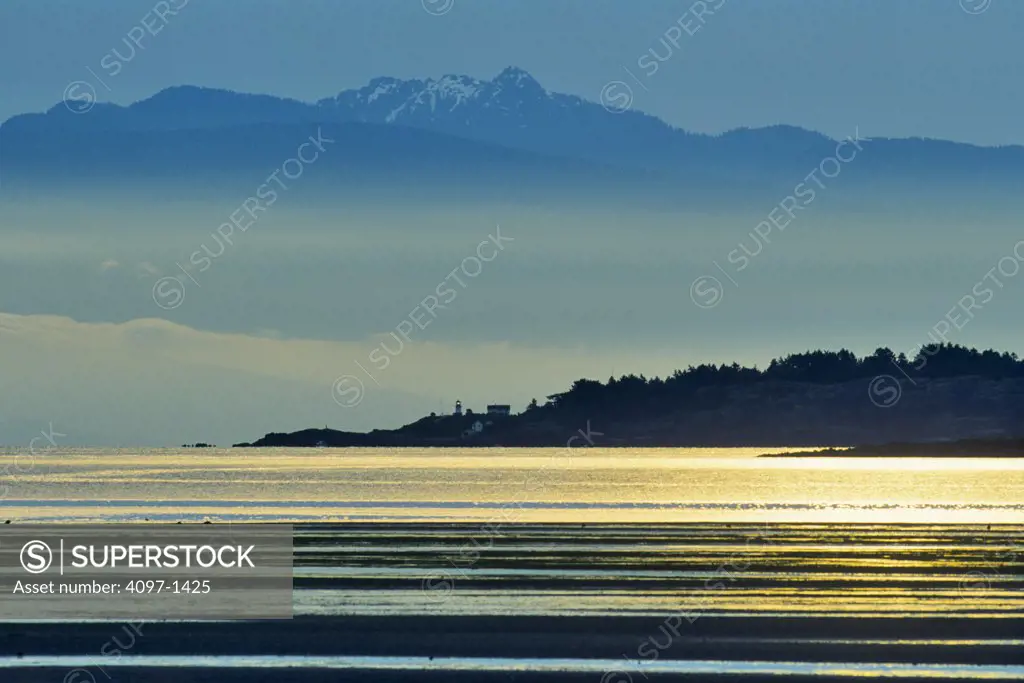 Silhouette of mountains at sunrise, Rathtrevor Beach Provincial Park, Parksville, Vancouver Island, British Columbia, Canada
