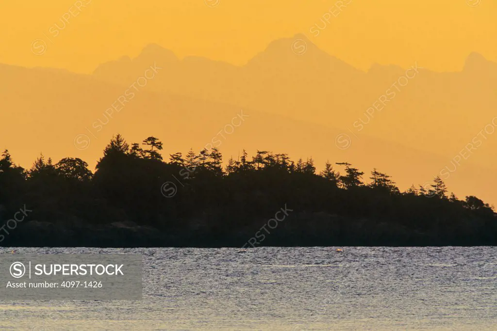 Silhouette of an island at sunrise, Vancouver Island, British Columbia, Canada