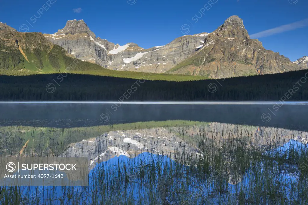 Reflection of mountains in a lake, Upper Waterfowl Lake, Banff National Park, Alberta, Canada