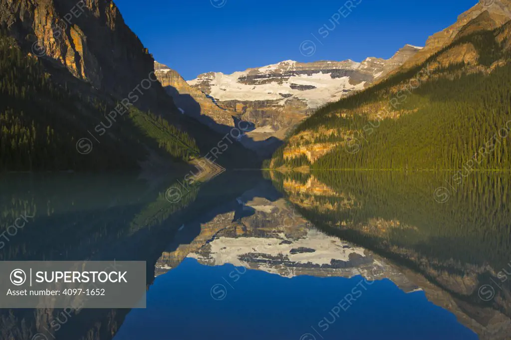 Reflection of mountains in a lake, Victoria Glacier, Lake Louise, Banff National Park, Alberta, Canada