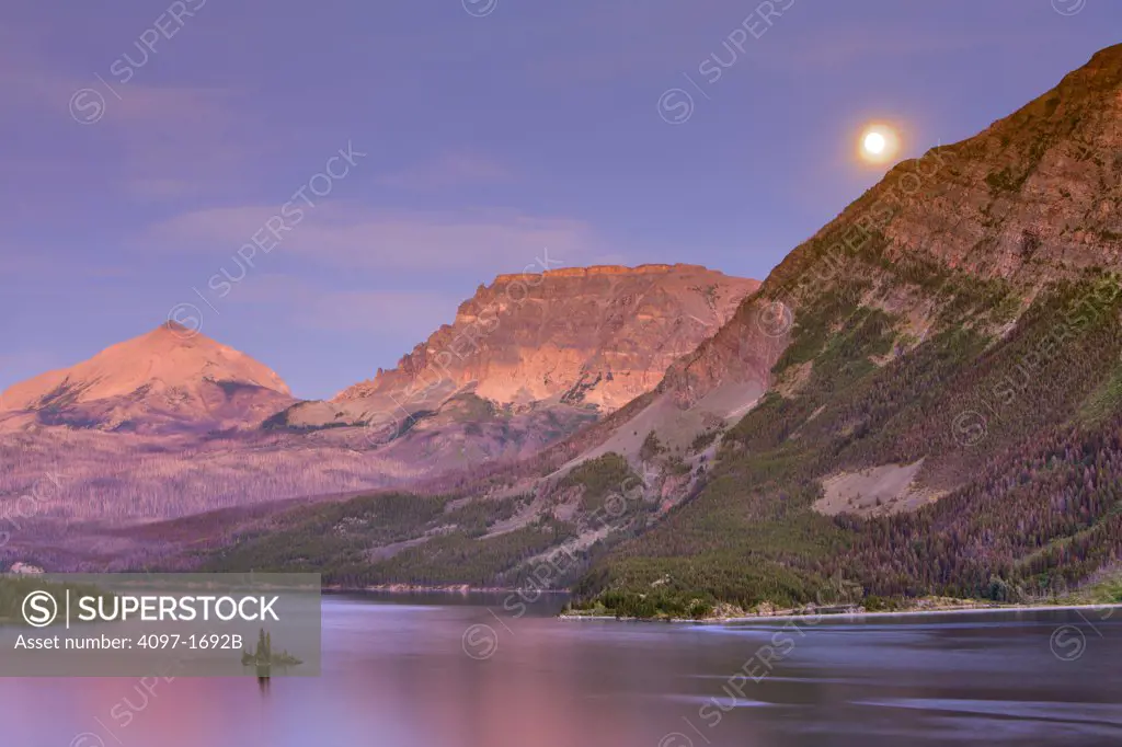 Lake with mountains at dusk, Saint Mary Lake, Wild Goose Island, US Glacier National Park, Montana, USA