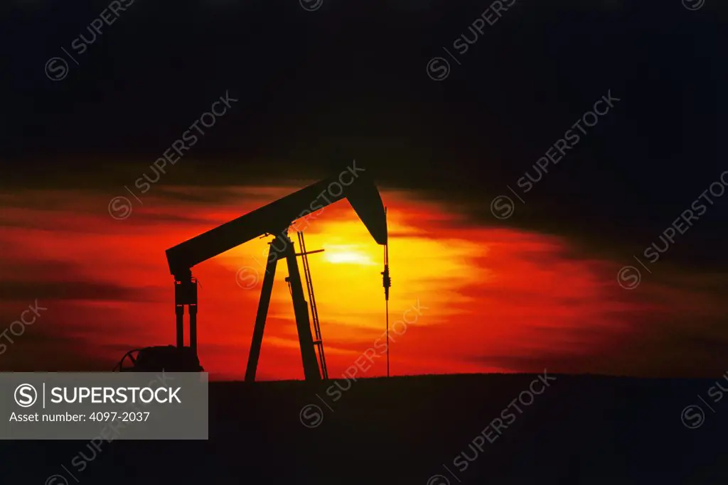 Silhouette of an oil pump jack, Drumheller, Badlands, Alberta, Canada