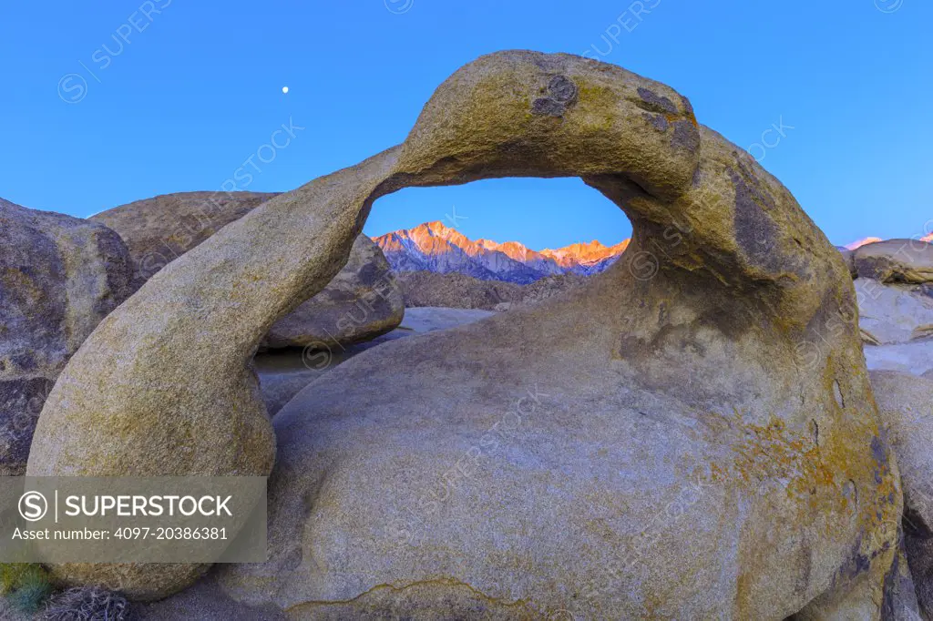 Moon set over Mobius Arch in Alabama Hills, California