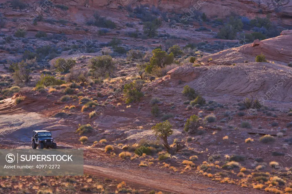 Jeep in a canyon, Poison Spyder Mesa, Moab, Utah, USA