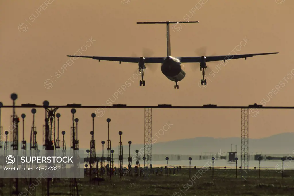 Silhouette of an airplane landing, Vancouver, British Columbia, Canada