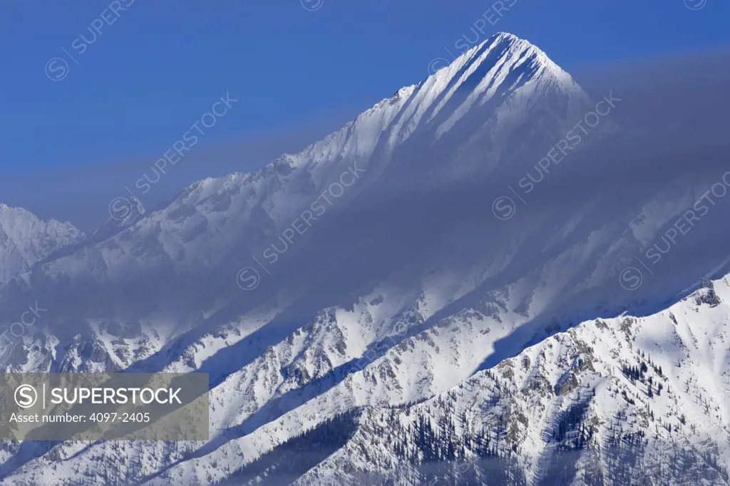 Clouds over snow covered mountains, Kootenay National Park, British Columbia, Canada