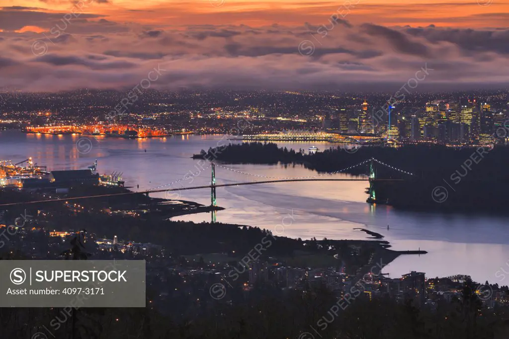 Canada, British Columbia, Vancouver, View of Lions Gate Bridge from Stanley Park at dusk