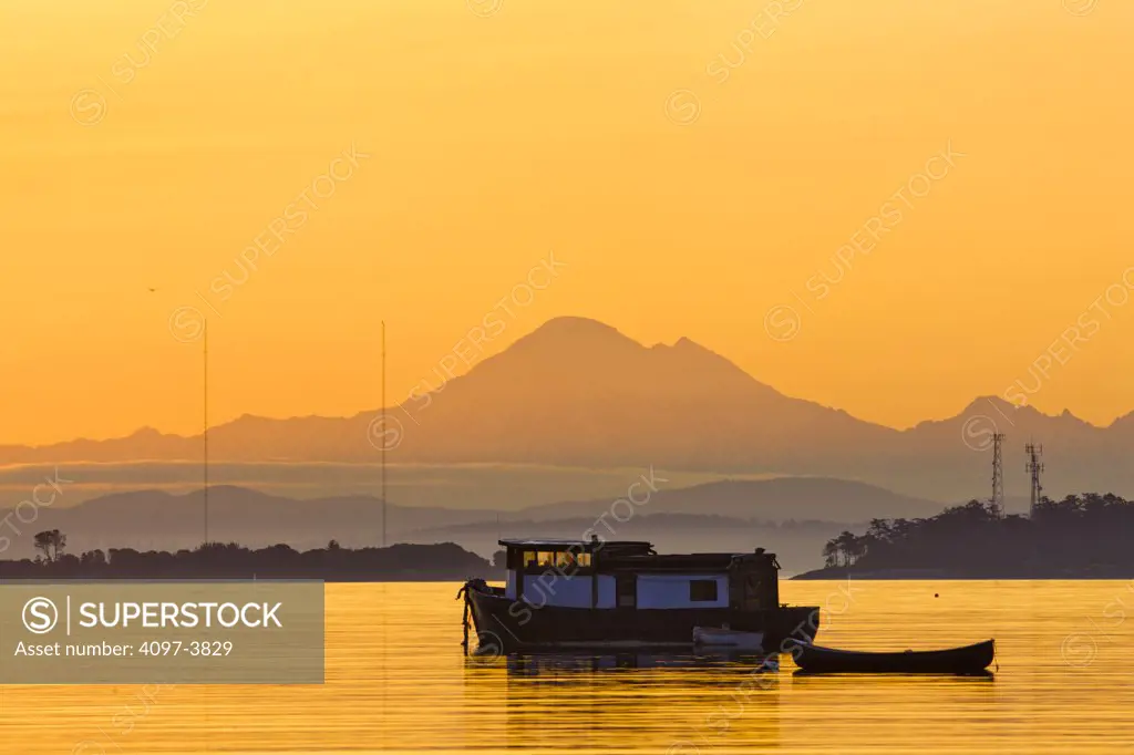 Canada, British Columbia, Victoria, boat floating on water at sunrise