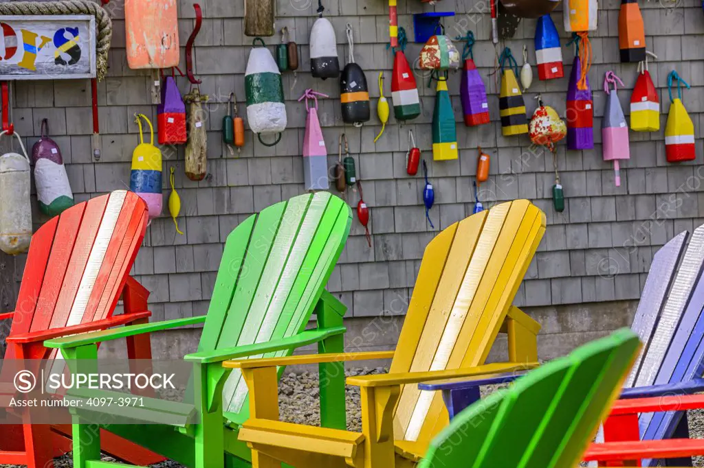 Adirondack chairs with buoys hanging on a wall, Blue Rocks, Nova Scotia, Canada