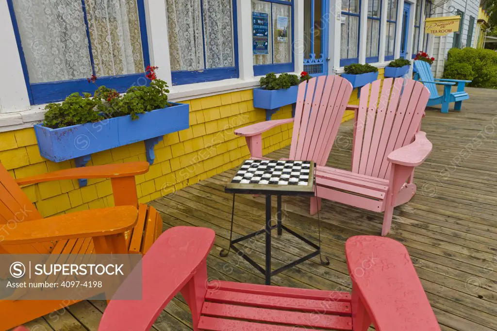 Chessboard on a stool surrounded by adirondack chairs, North Rustico, Prince Edward Island, Canada