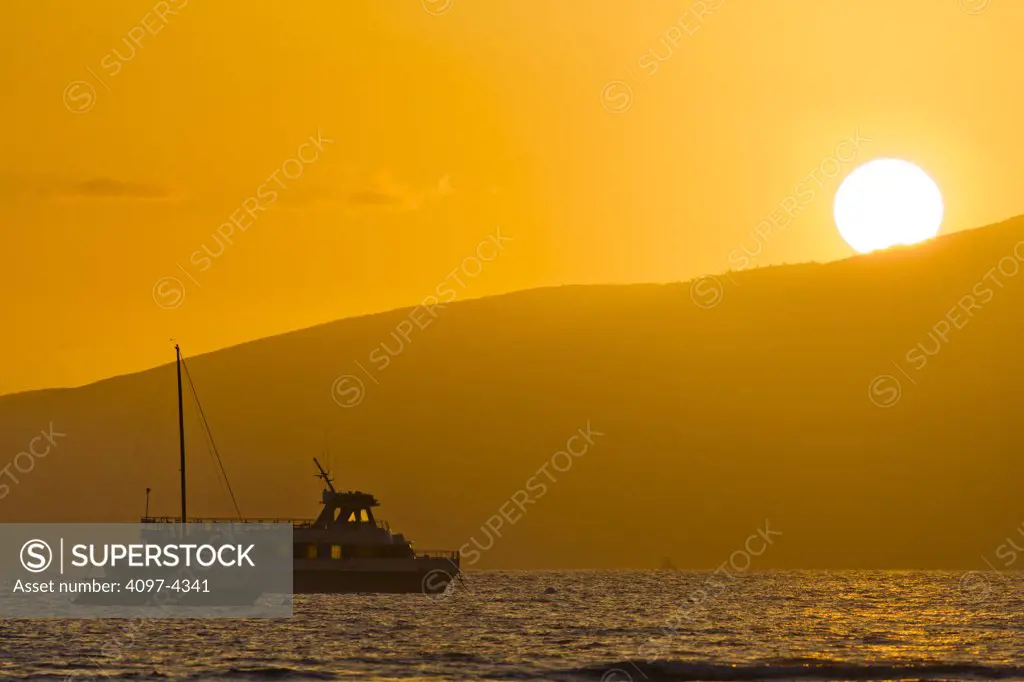Boat anchored off Lahaina Harbor at sunset, Maui, Hawaii, USA
