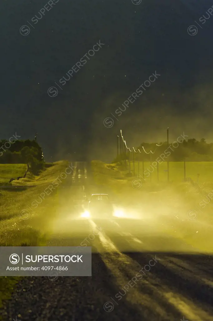 Canada, Alberta, Vehicle creating dust on country road