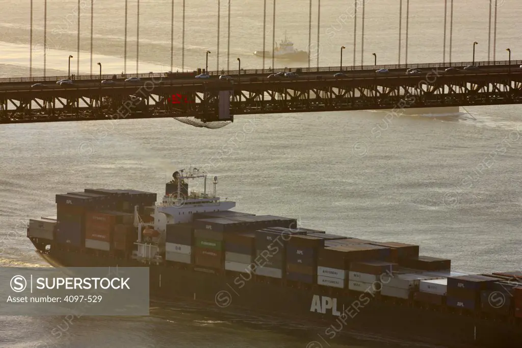 Container ship passing under a bridge, Golden Gate Bridge, San Francisco Bay, San Francisco, California, USA
