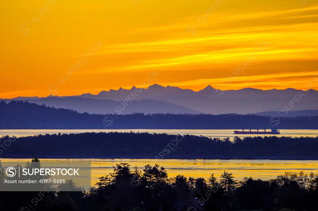 freighter in Haro Strait with Mount Baker in distance at dawn, seen from Victoria