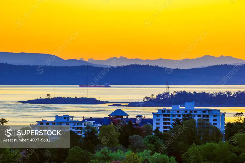 freighter in Haro Strait with mount Baker in distance at dawn, seen from Victoria