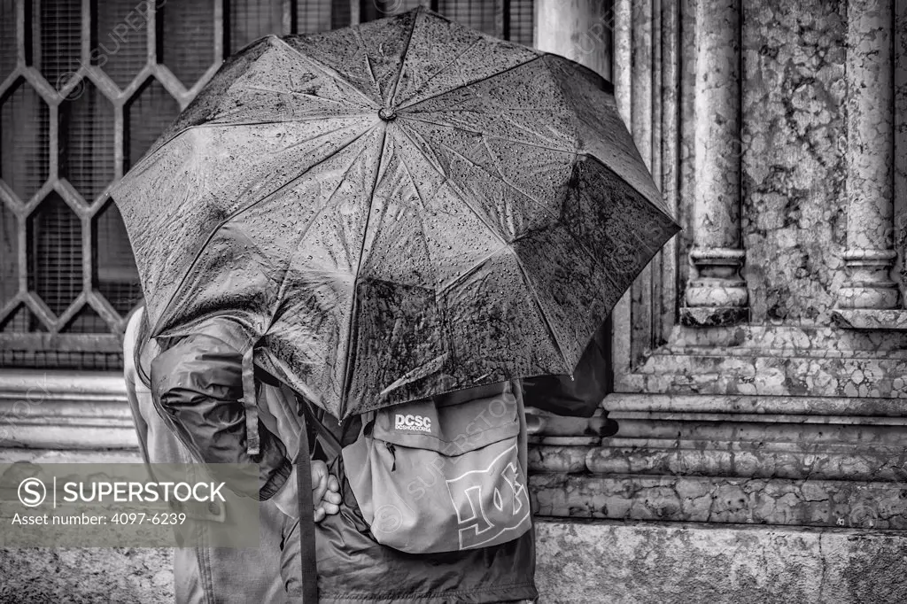 tourists in the rain with umbrella