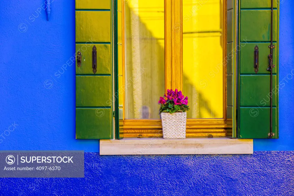 window reflecting bright yellow wall, Island of Burano off Venice