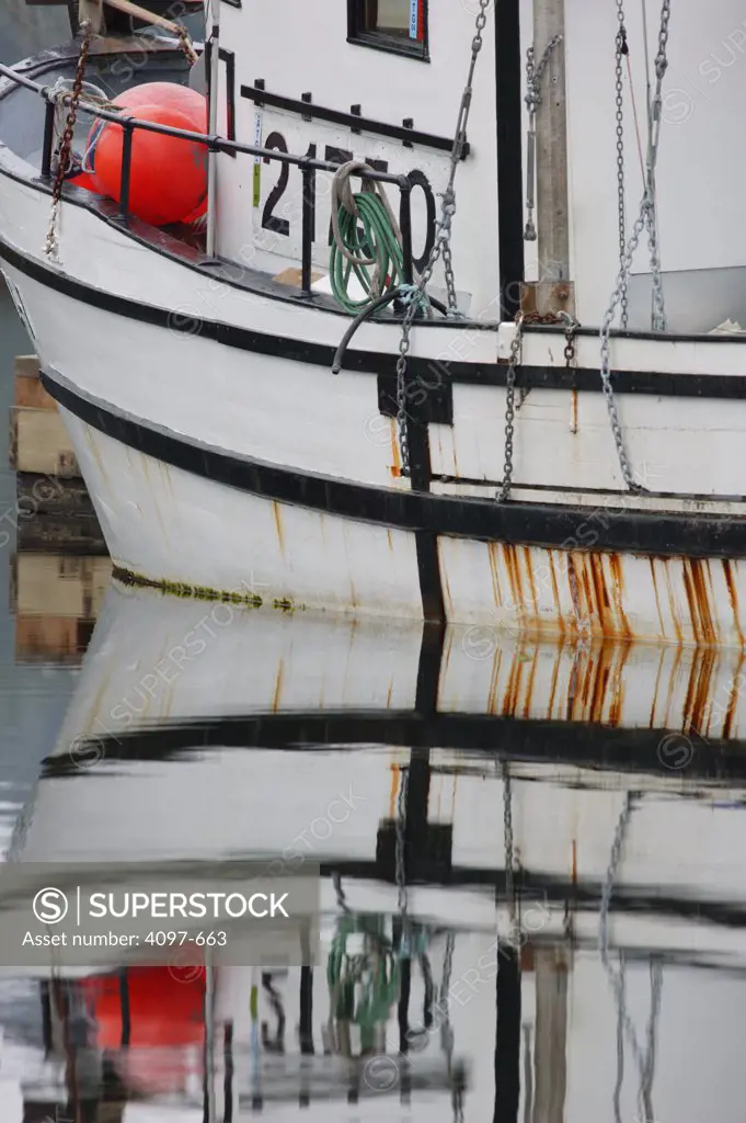 Reflection of a fishing boat in water, Pacific Rim National Park Reserve, Ucluelet, British Columbia, Canada