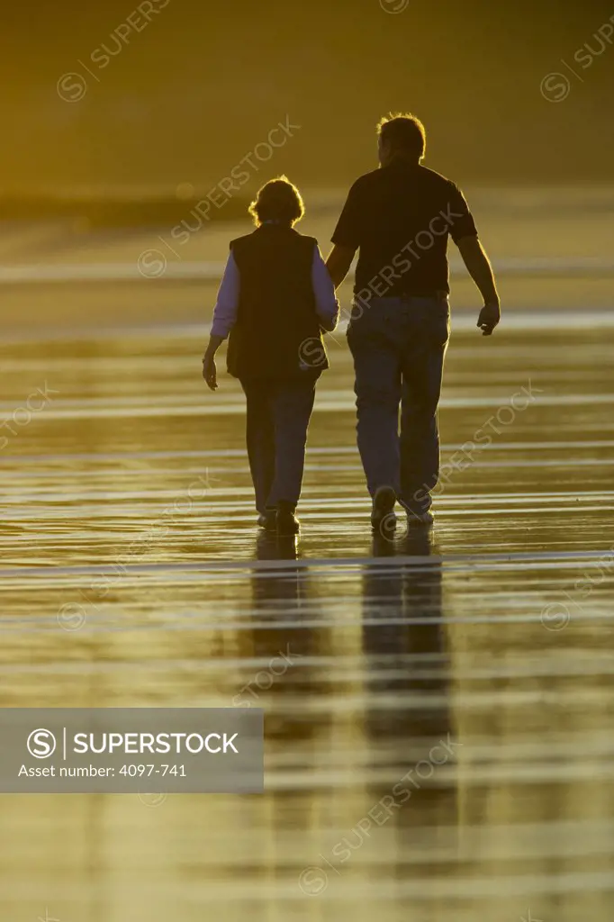 Couple walking on the beach, Long Beach, Pacific Rim National Park Reserve, Vancouver Island, British Columbia, Canada