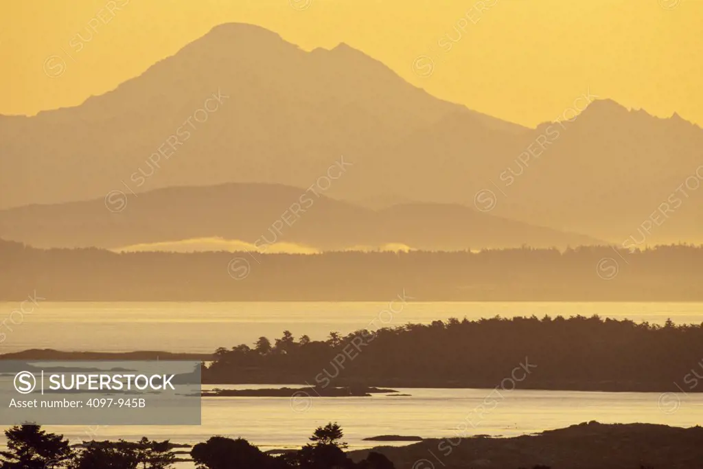 Island with mountain range in the background, San Juan Island, Mt Baker, Haro Strait, Saanich Peninsula, Vancouver Island, British Columbia, Canada