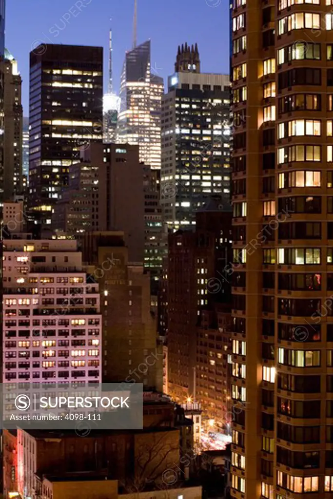 Skyscrapers in a city lit up at night, New York City, New York State, USA