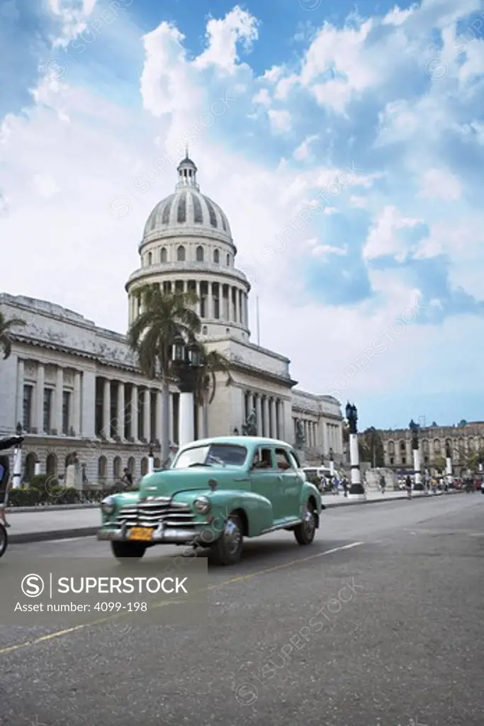 Car on the road in front of a government building, El Capitolio, Havana, Cuba