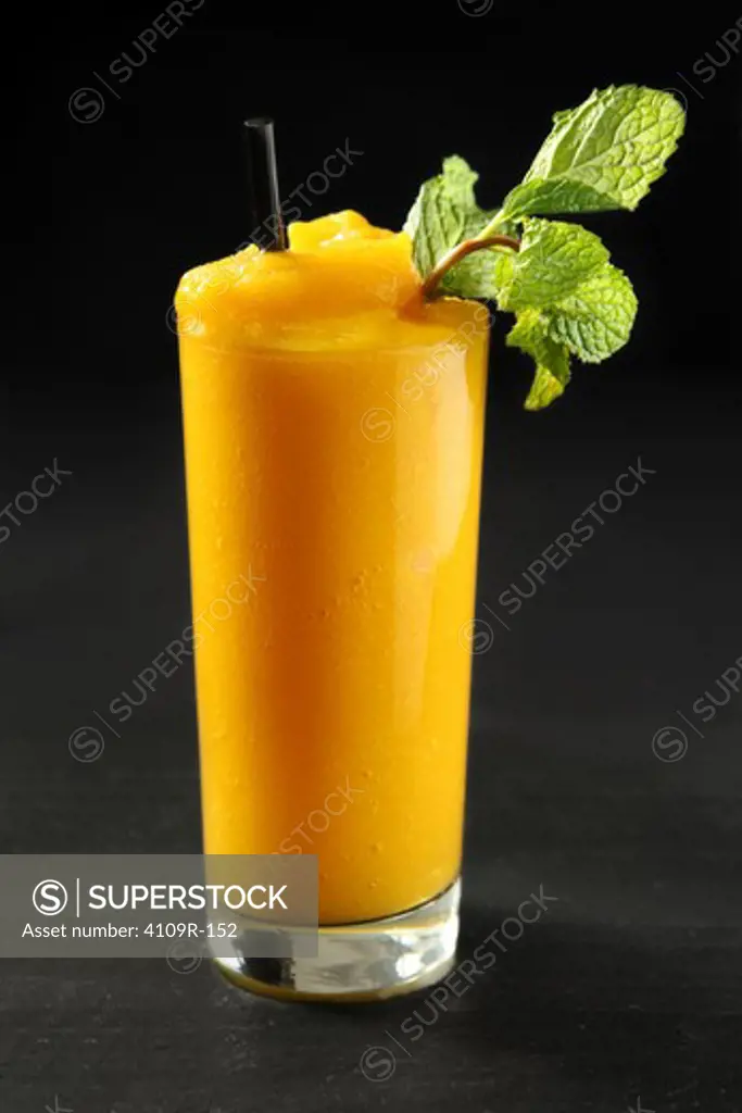 Close-up of a mango smoothie with mint sprig