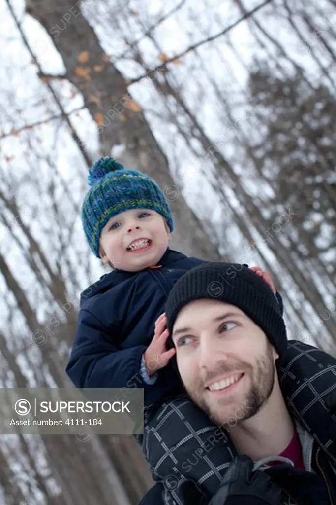Father carrying his son on his shoulders, Traverse City, Grand Traverse County, Michigan, USA