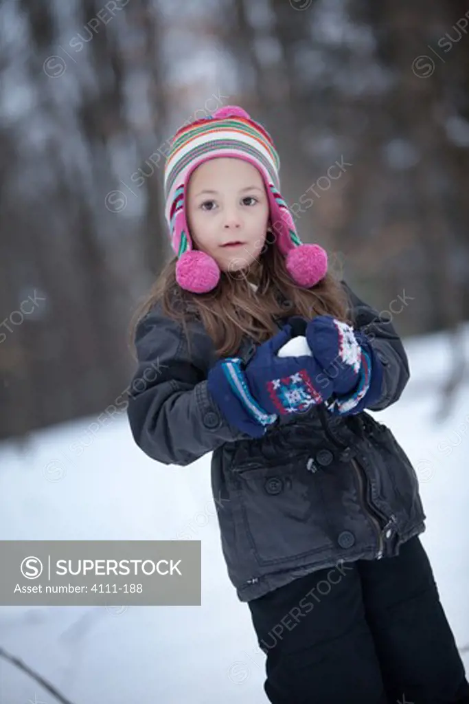 Girl holding hot chocolate in snow, Traverse City, Grand Traverse County, Michigan, USA