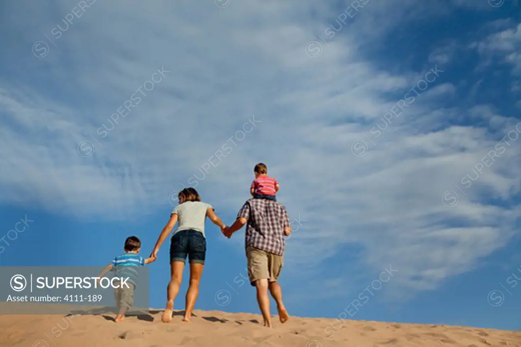 Family walking up a sand dune on the beach, Sleeping Bear Dunes National Lakeshore, Glen Arbor, Leelanau County, Michigan, USA