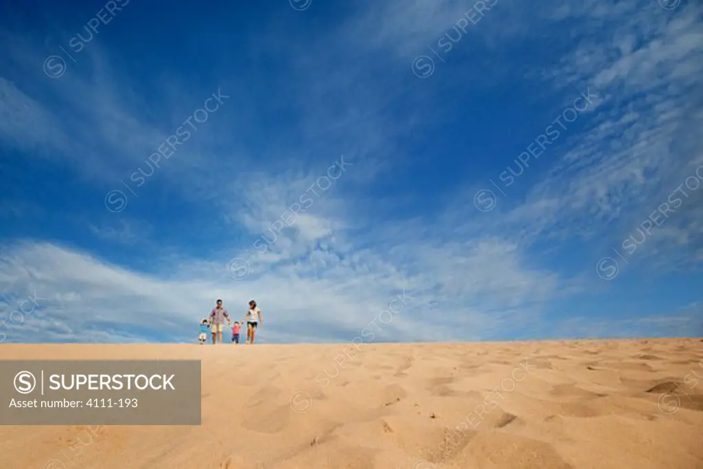 Family walking down a sand dune on the beach, Sleeping Bear Dunes National Lakeshore, Glen Arbor, Leelanau County, Michigan, USA