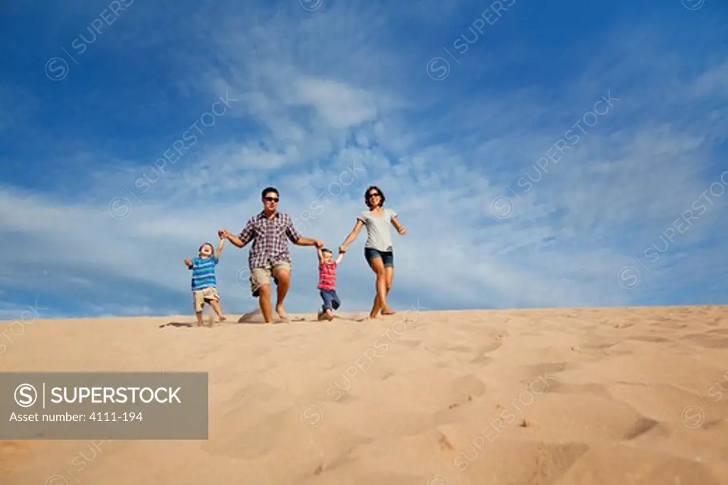 Family walking down a sand dune on the beach, Sleeping Bear Dunes National Lakeshore, Glen Arbor, Leelanau County, Michigan, USA