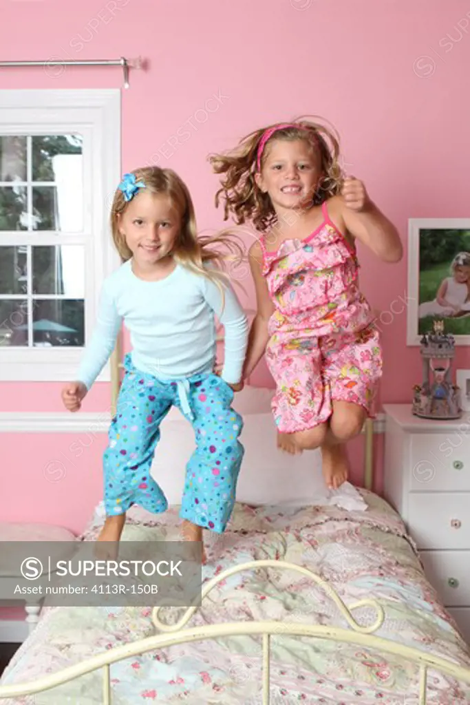 Girls jumping on the bed