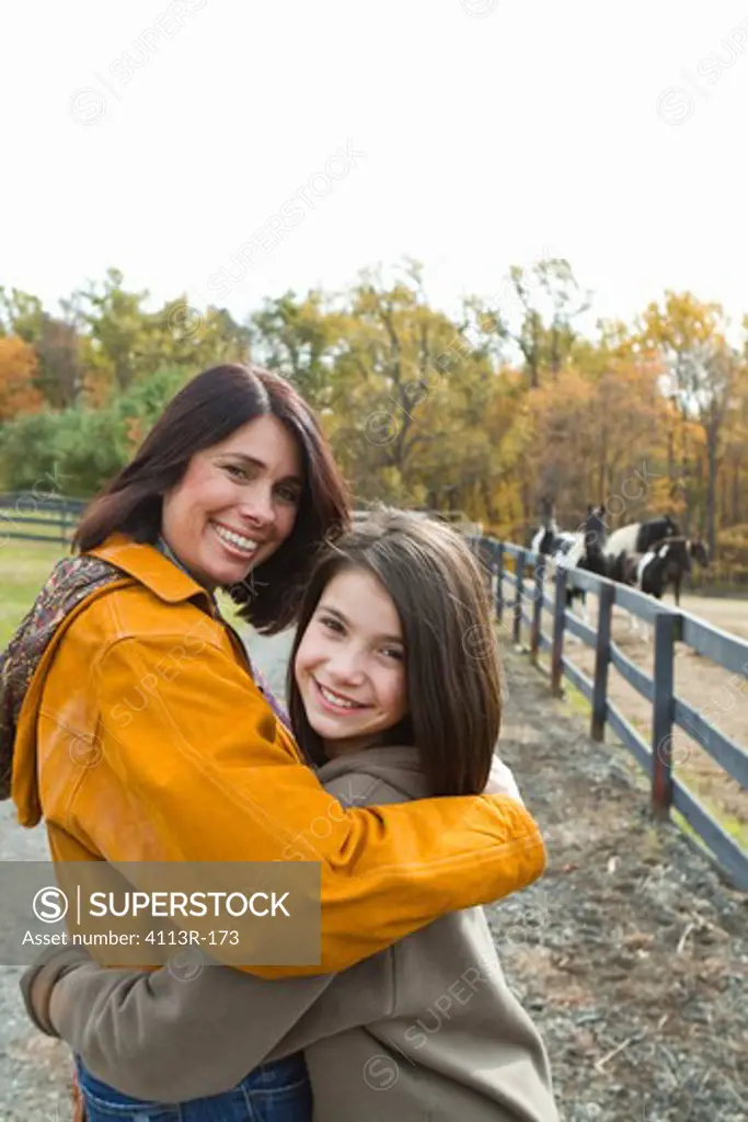 Portrait of mother and daughter on field